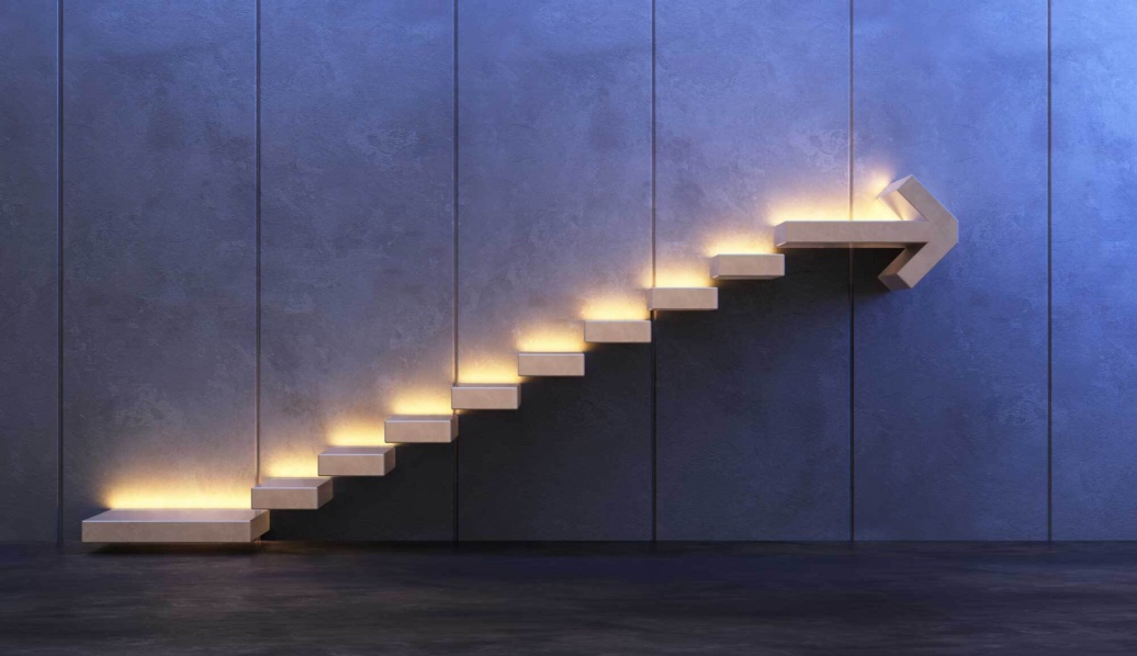 Steps set into a wall with the top step in the shape of an arrow.