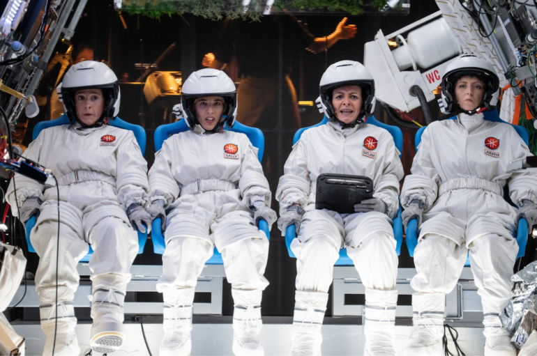 Four actors dressed as astronauts